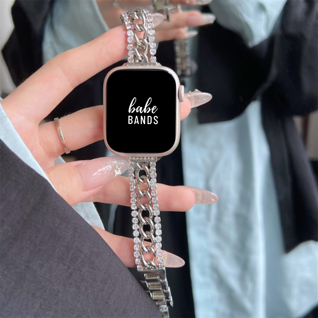 No more basic vibes. Step up your babe game with our premium Babe Bands to elevate your style.   Upgrade your Apple Watch with our Premium Crystal Railroaded Chain Band Apple Watch Band.  Indulge in the luxury look and feel of our Apple Watch band, crafted in an design with a mid-size chain lined with a row of faux diamonds down each side for added style.