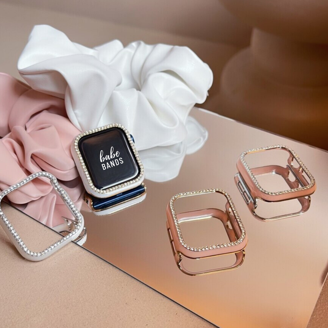 No more basic vibes. Step up your babe game with our premium Babe Bands Case to elevate your Apple Watch style.    Upgrade your Apple Watch with our Premium Single Row Rhinestone Contrast Apple Watch Bumper Case.  Indulge in the luxury look of our Apple Watch case, crafted from high-quality materials including a durable Polycarbonate case with a contrast color trim and a single row sparkling faux diamond border.