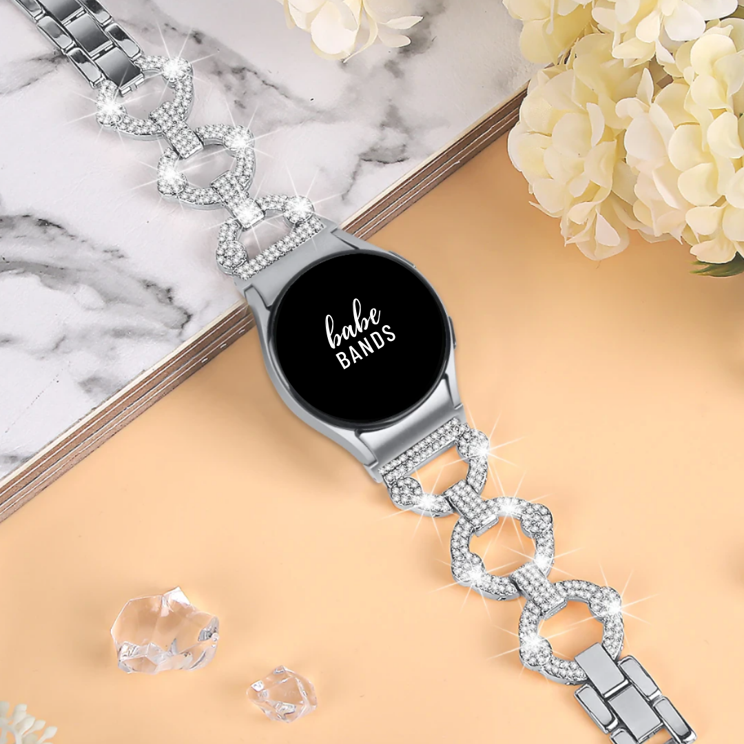 No more basic vibes. Step up your babe game with our premium Babe Bands to elevate your style.   Upgrade your Samsung Galaxy Watch with our Premium Crystal Embellished O-Chain Band Samsung Galaxy Watch Band.  Indulge in the luxury look and feel of our Samsung Galaxy Watch band, crafted from high-quality stainless steel in an elegant o-chain style, with shining faux diamond embellishments. 