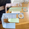 Is your love for matching your Apple Watch Band to every outfit causing a cluttery mess and giving you a headache?  Don't worry, we've got you covered. Babe Bands' Apple Watch Band Holder + Charging Station will help you declutter your counter and mind. Made from stainless steel, this sturdy and minimalist styled storage solution can hold up to 9 of your favorite Apple Watch Babe Bands, and has a convenient spot to store and charge your Apple Watch, all in one location!